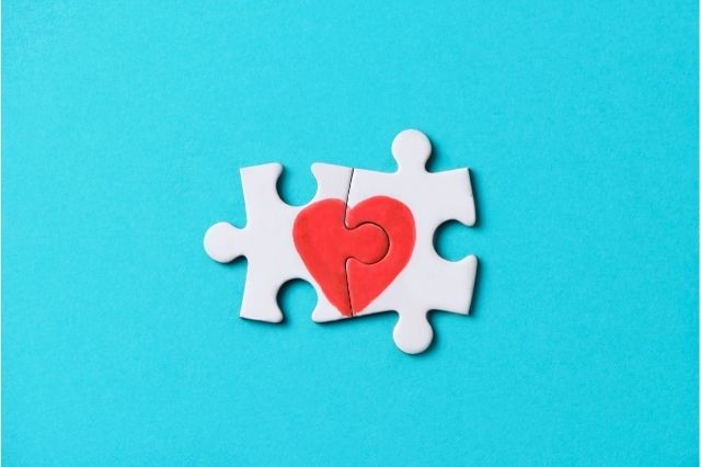 two puzzle pieces making up the image of a heart