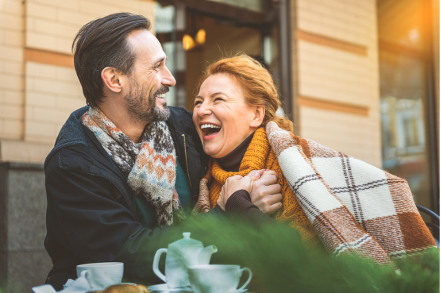 Couple all rugged up laughing together