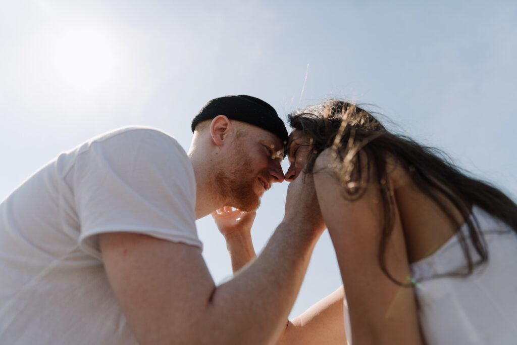 Couple smiling at each other with their eyes closed and foreheads touching