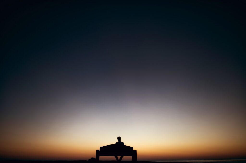 person sitting alone on a bench