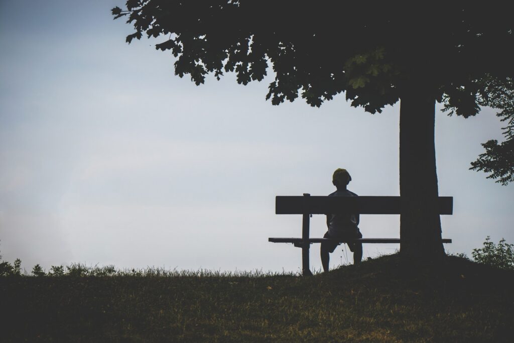 Young man sitting by himself