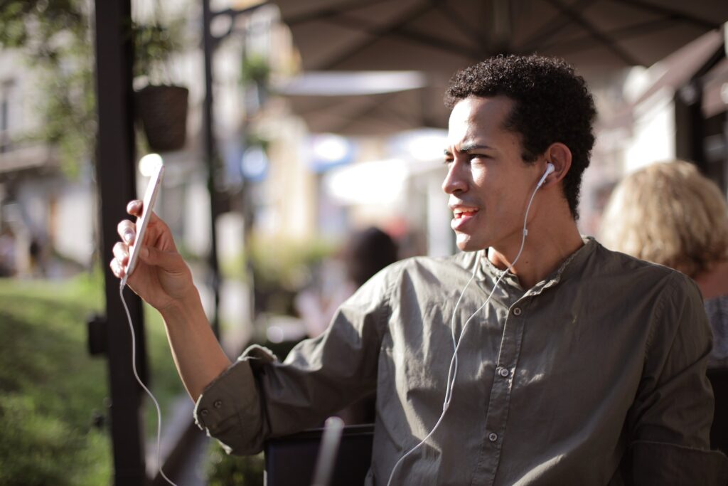 African American man making video call in street cafe
