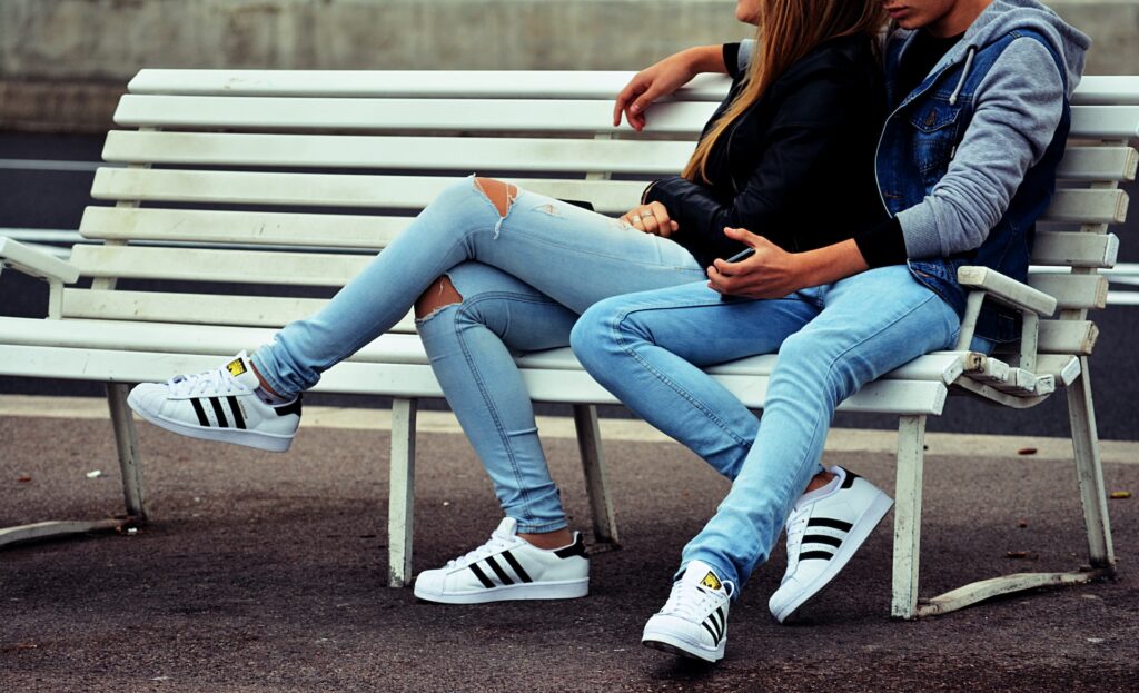 young couple sitting on bench